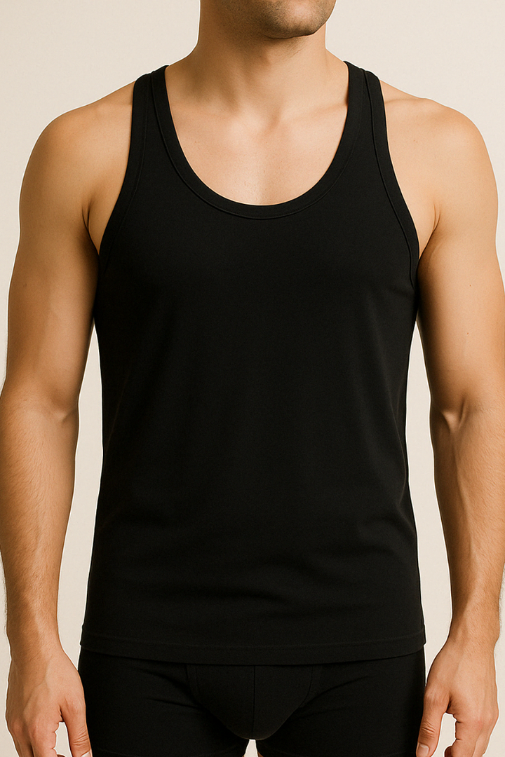 A male model wearing a black cotton sleeveless undershirt and boxers.