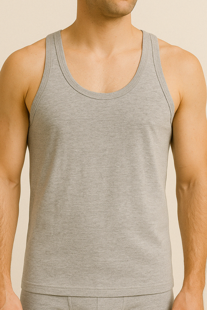 A male model wearing a gray cotton sleeveless undershirt and boxers.