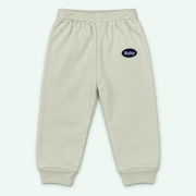 100% cotton baby cuffed pants - Cream with Baby label on pastel mint