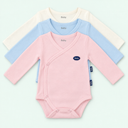Baby long-sleeve wrap bodysuits in pink, light blue and ivory on pastel mint