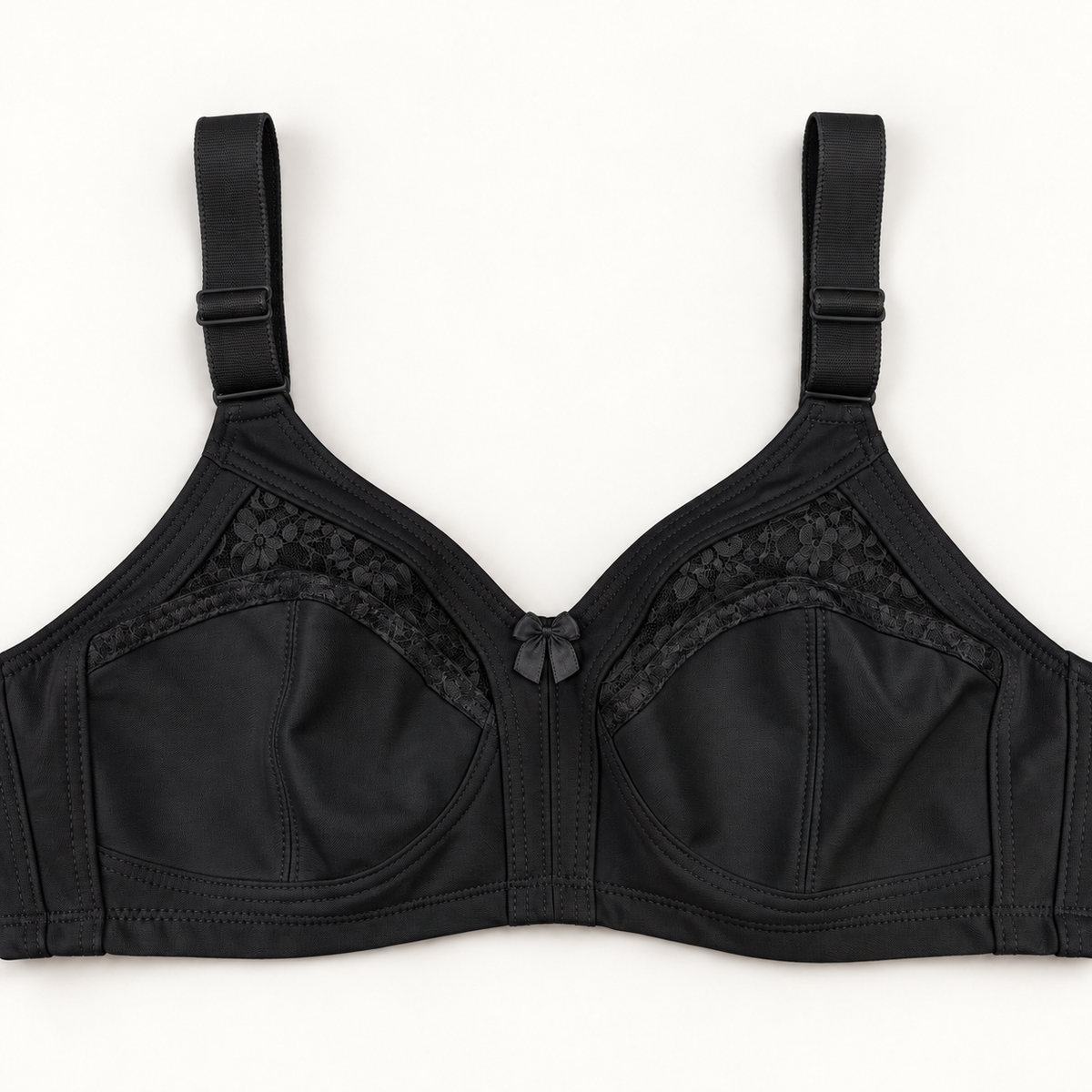 Black non-padded bra with seamed cups, curved floral-lace inserts, wide adjustable straps and a small centre bow.