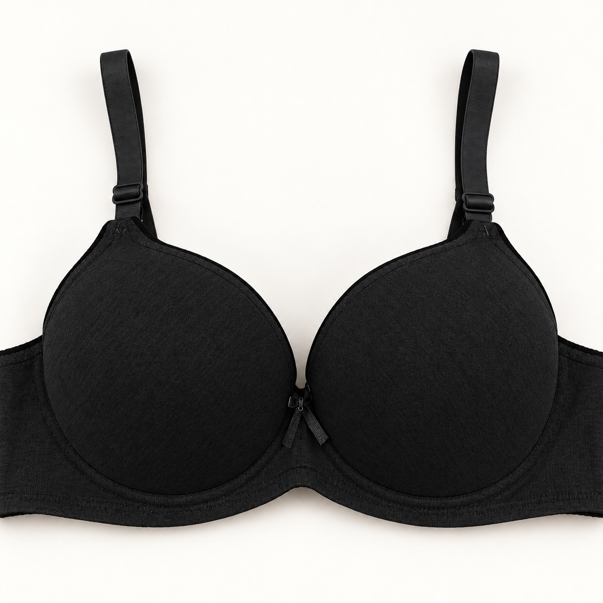 Black push-up bra with black trim and matching adjustable straps, front view.