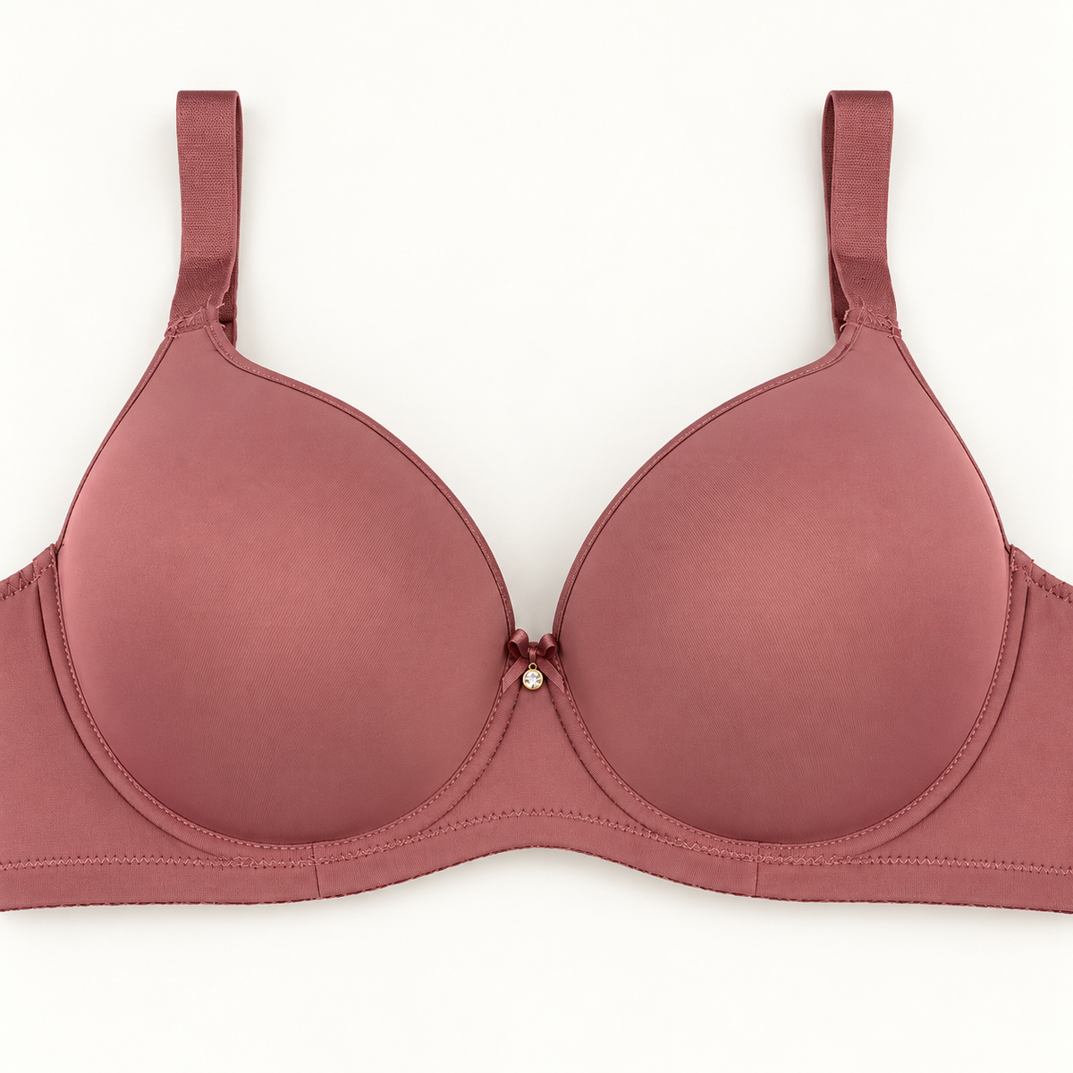 Dusty rose push-up bra with smooth cups, matching straps and a plain band. Finished with a small centre bow and dangling charm.