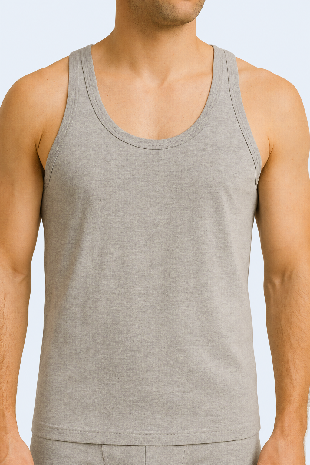 A male model wearing a gray cotton sleeveless undershirt and boxers.