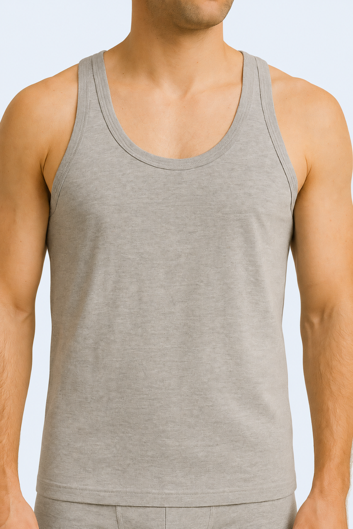 A male model wearing a gray cotton sleeveless undershirt and boxers.