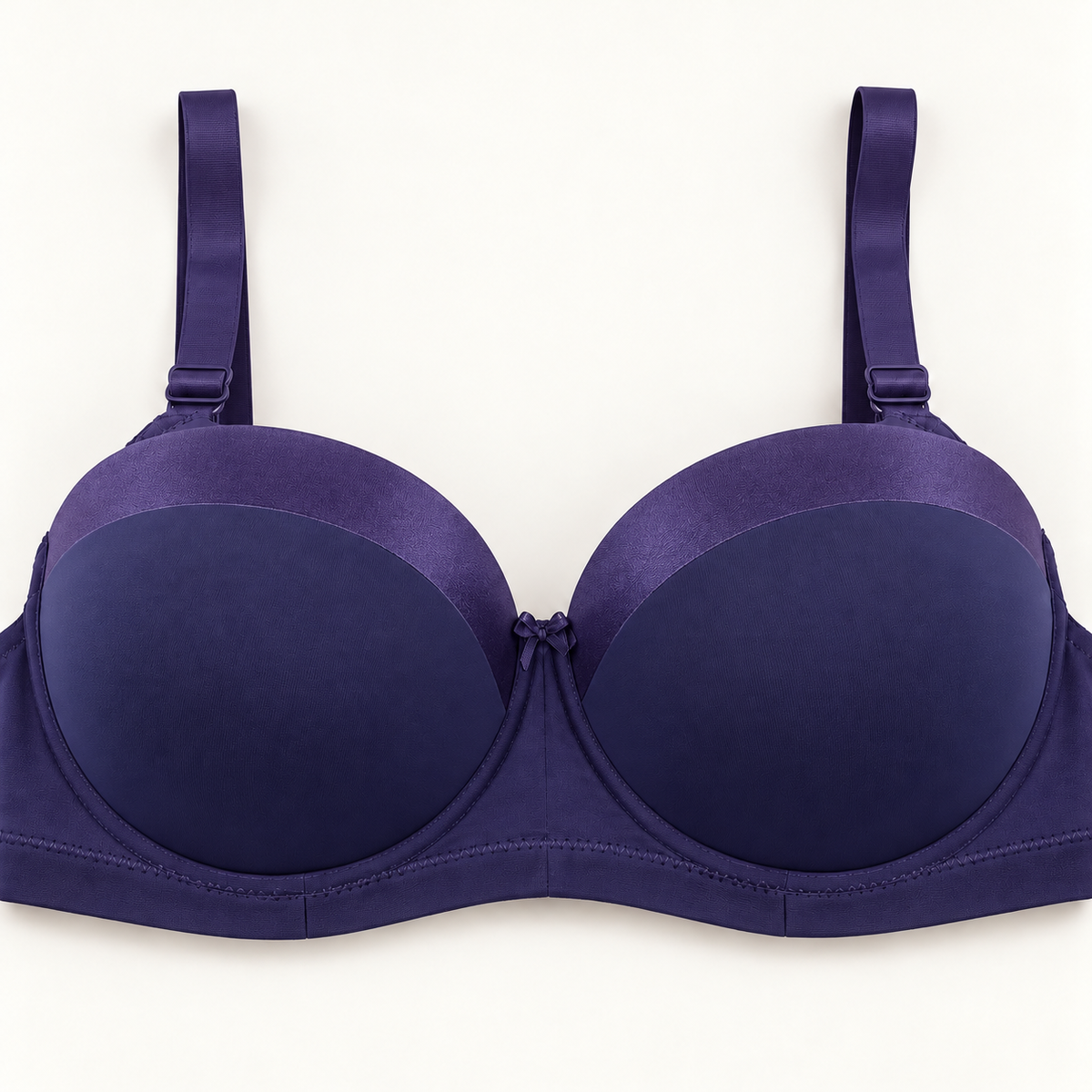 Purple push-up bra with contrasting violet curved panels along the upper cups. Finished with matching straps, a plain stitched band and a small centre bow.